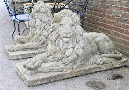 A pair of reconstituted stone garden statues modelled as seated lions, 4ft